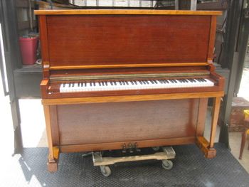 1915 Baldwin midsized upright after repairs and a natural refinish with no stain, yellow looking parts are actually cherry, just looks yellow in the sunlight.
