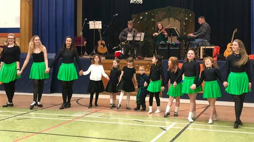 Seventh Town Ceili band on stage accompanies Irish dancers from McGrath School of Irish Dance in Kingston, Ontario