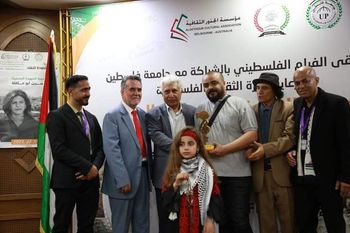 Rasheed Anbar (Abu Maher) collects the prize for best documentary at al-Awdah festival, Gaza, May 2022
