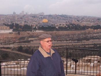 Pastor preaching on the Mount of Olives overlooking the Holy City.
