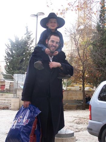 A Jewish father and son heading off for the days work.
