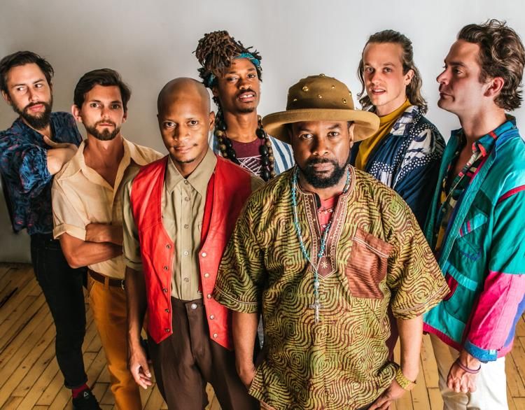 Kaleta and Super Yamba Band standing close together for a group photo shoot