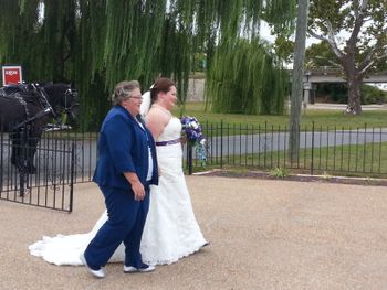 Bride walking in with mother to ceremony.
