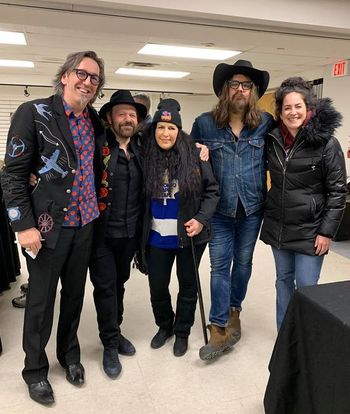 With Blackie & The Rodeo Kings https://www.blackieandtherodeokings.com/
