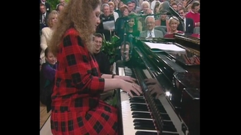 Tracey playing "I'll Be True" on a Gaither video with her good friends Roger Bennett and Anthony Burger looking on.
