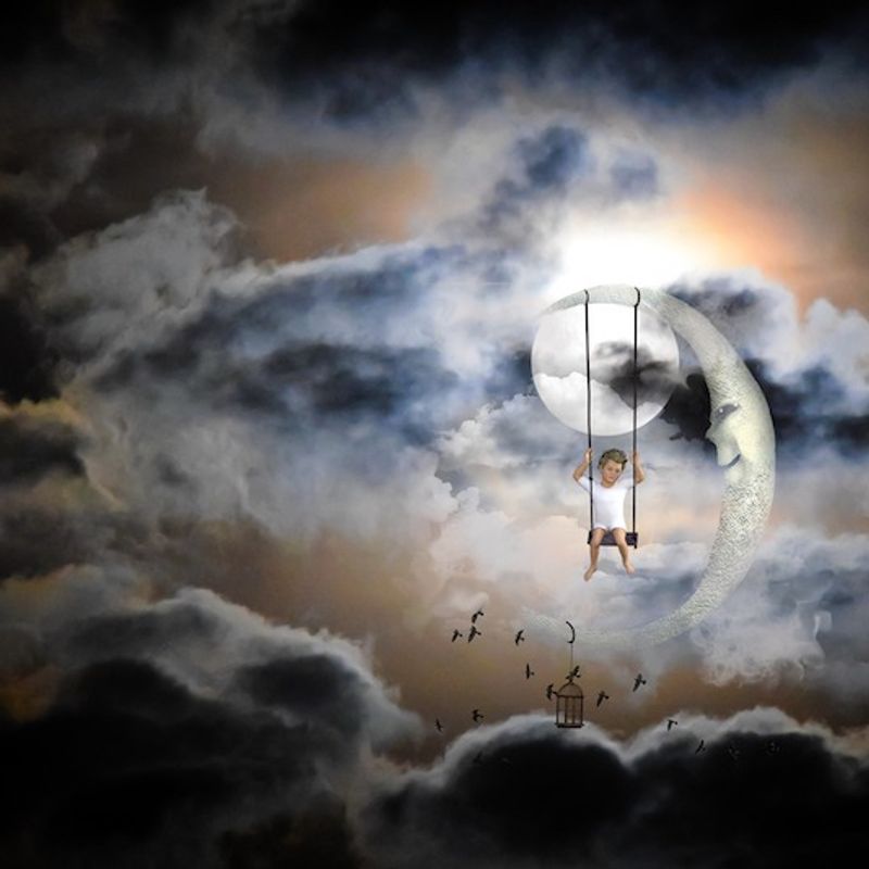 Fantasy image of child swinging from the moon