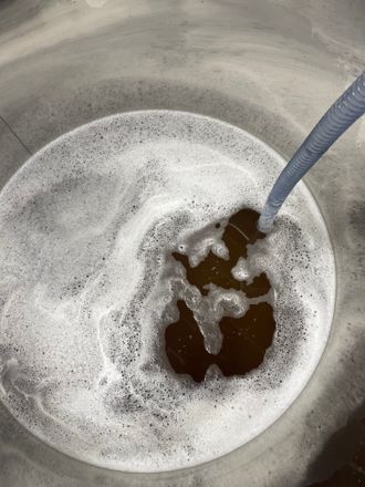 Visual of cider inside of the giant metal cider vat