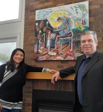 James McGowan and An Nguyen, with her painting "Reaching Out" in background.
