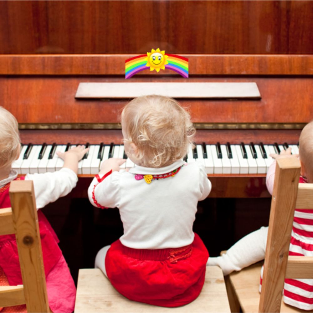 3 Toddlers sitting at a piano.