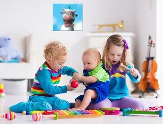 Image of 3 children playing on the floor with musical instruments.