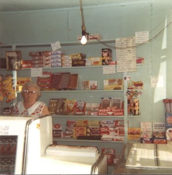 My great Aunt Helen stands behind the counter filled with all sorts of treats.

