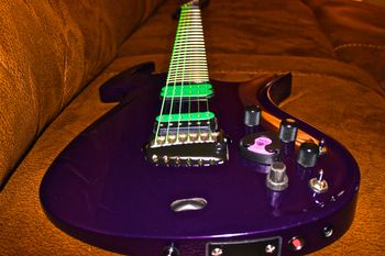 (10/22/2013) This is the most recent Parker that I picked up, funny thing is it is an exact duplicate of my first Parker that I still own. It is was made in 1998 and is a Fly Deluxe. It has a Poplar body with a Basswood neck. It has DiMarzio pickups in the neck and bridge and a piezo in the bridge. The pickups are stock but have vinyl covers from universaljems.com. Two of the coolest features on the earlier Parkers are a switch to block and unblock the floating bridge on command and a red L.E.D. that lets you know when the battery is almost dead. I call this my Grave Digger Parker because it matches the colors found on the famous monster truck.
