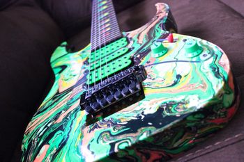 (12/24/13) This may be one of the coolest looking guitars I have and have ever seen for that matter. It is an Ibanez Universe UV77MC Swirl. These were first made in 1990. The Ibanez Universe is the first mass-produced solid body seven-string electric guitar, developed by Steve Vai and manufactured by Ibanez. It has a Basswood body and Maple neck and Rosewood fretboard. It has the disappearing pyramid inlays. It also has DiMarzio Blaze II pickups in the bridge, middle and neck. Ibanez made a 20th anniversary reissue of this guitar, but this is the original. Just a super cool guitar to look at, oh and it plays and sounds great too.
