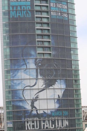 poster for Red Faction covering the side of the Omni hotel
