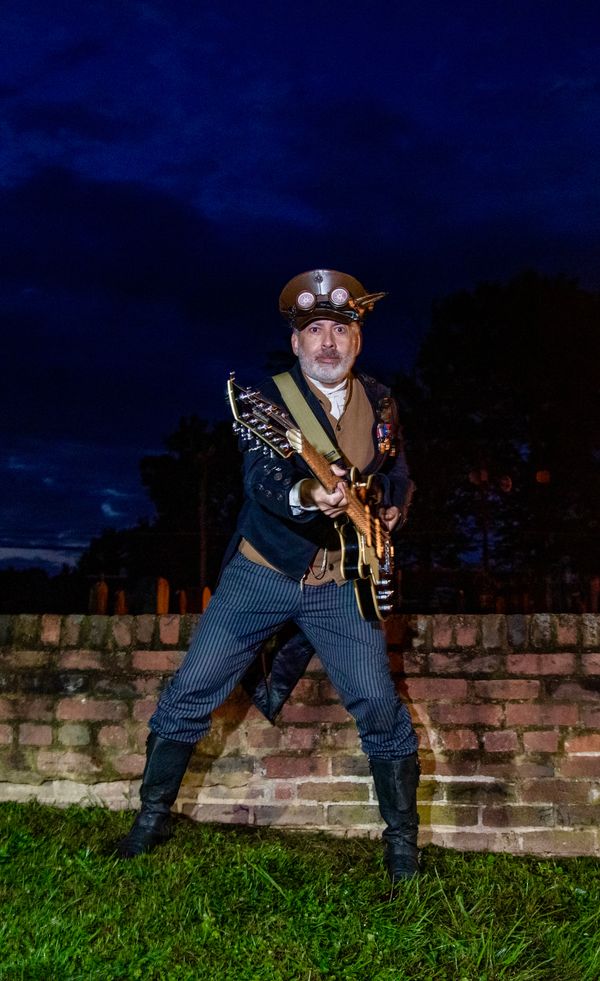 Captain R.A. Hunt -
Low end frequency director. Serial lyricist. Melodic induction manager and Professor Emeritus songsmith. Vocals, acoustic guitar, bass and accordion.