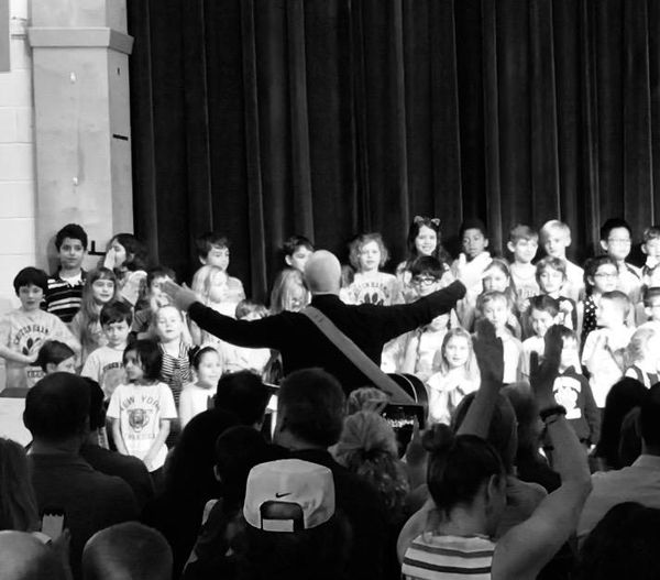 Paul directing an elementary school performance in his hometown of Croton on Hudson, NY.