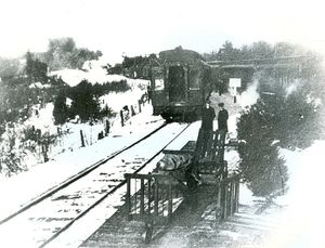 This rare image shows two trains at the northerly end of the station platform. One is clearly northbound, the other presumably southbound. The ball of the CPR water tank is just visible near the top left corner. Believed to be circa 1904 in light of the window vestibule of the last car on the left, identified by Doug Philips. Peel Art Gallery Museum and Archives.