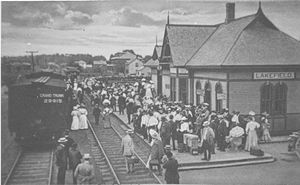 Busy Lakefield on an excursion day, looking south to Peterborough. The station building is still at its original location. Ca 1910 in the Grand Trunk era.