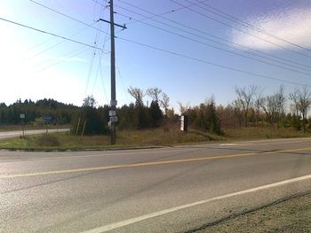 Looking southwest towards Dunsford in 2017 at the junction of CKL Roads 24 and 36. The large advertising sign sits on the former right-of-way.