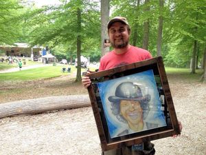 Jon with portrait of John Hartford, donated to the festival and raffled.