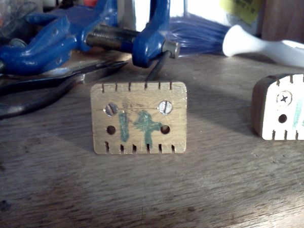 7/1/14 - #14 - Here is the head block / string retainer with slots roughed in, from the mounting face view.
