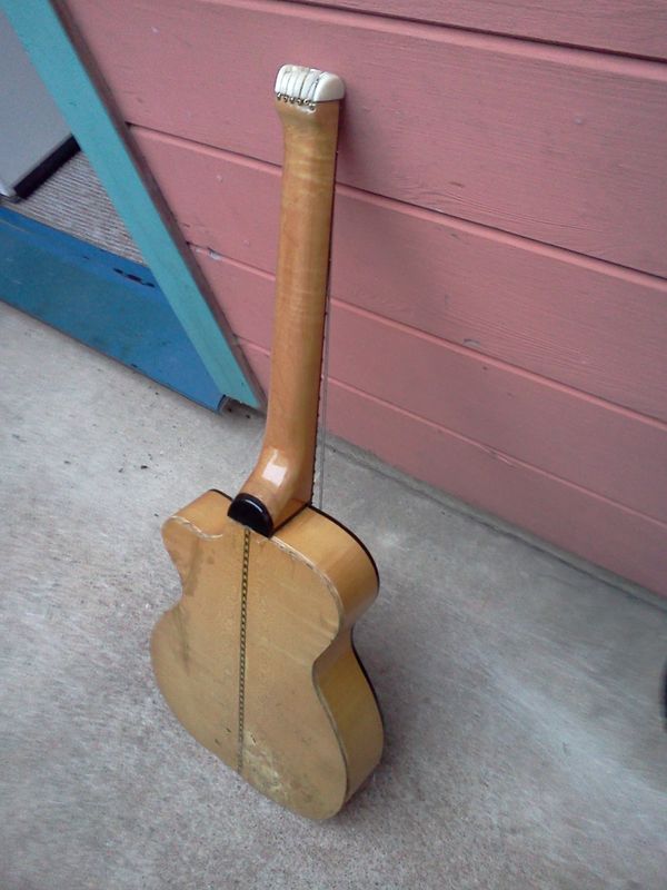 6/30/14 - #8 - Back view of number eight, showing the nice tiger stripe figuring of it's German Maple on the back, sides, and neck. This was a road guitar for a while, and spent it's first ten years without a case, and spent at least a dozen flights in overhead baggage compartments, and countless years being tossed around with way too many temperature and humidity extremes. Oh, and a bad emergency surgery of pulling the back off with just a gas stove and a butter knife. What a hard life...