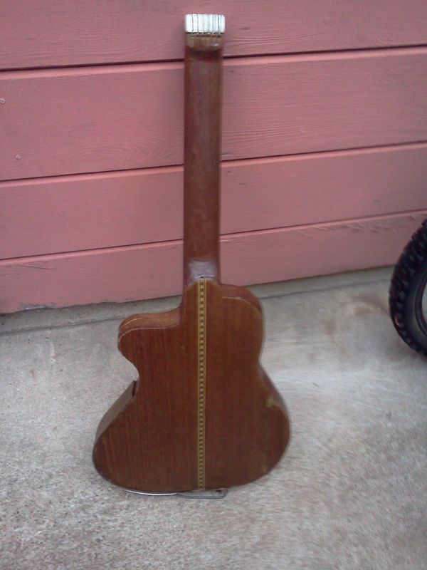 6/30/14 - #10 - Rear view, showing off that teak back, with a crack or two, and some Arizona mud. Kind of rough, but even with no neck reinforcement, this has been a great traveling guitar, it even fits in my Trader Joe's bag with my purse, and water, miscellaneous stuff.