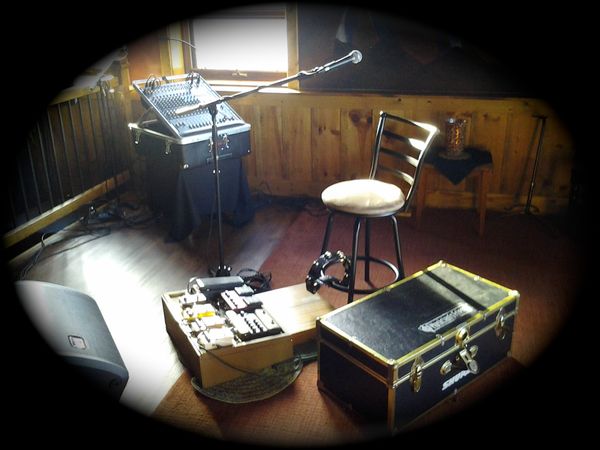 My current live setup with wooden foot stomp box, guitar pedalboard and the tambourine chair.