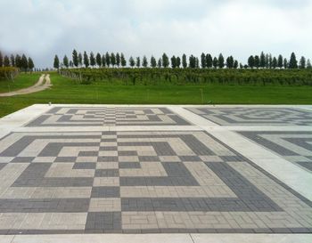 Concrete cobblestone pad for Big Top Tent beside Free Parking grass area. Background road is the entrance to the grounds