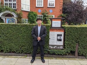 standing in front of Sigmund Freud's London home