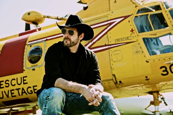 Jason with the Canadian Armed Forces Labrador Helicopter in the background. Jason’s father flew this very helicopter during his career as a Search and Rescue Pilot. The song “That Others May live” pulls from Jason’s memories of this.