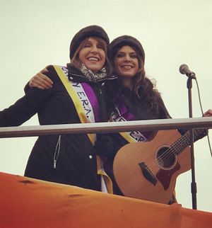 Photo of Ali Handal and I after we sang We Can Do It from the top of a large orange dragon on the National Mall.