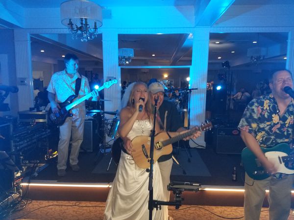 Bride Nicole joins the band on stage for a tune during her wedding reception. Congratulations again, Nicole and Ed!