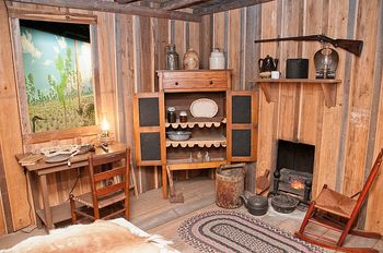 Interior and some typical furnishings of the 1800s. You can tell by the furniture and rugs that the owners were better off than most of the Crackers who were barely making it during that period.
