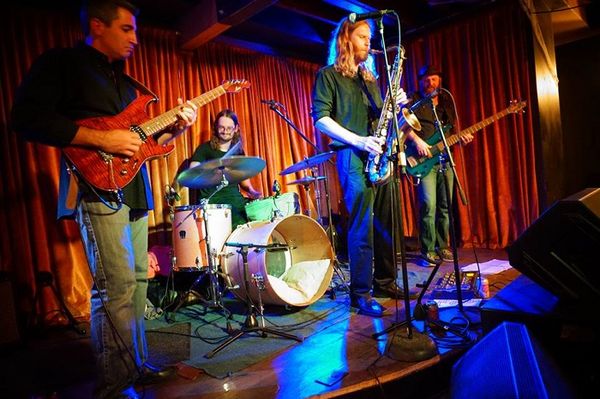 Guest article by Lauren Lyman
On June 13, 2015, the first VoyagerFest commenced in the cozy West Austin backyard of The Rusty Mule. A good number of the bands that performed were based in progressive rock and its many subgenres, but the festival also showcased avant garde, electronic (intelligent dance music), and other acts with experimental and innovative properties.
Beginning on Jan. 24, 2016, VoyagerFest launched a concert series called Voyager Nights, a place for bands from the previous year’s festival to continue performing and spreading awareness for the second annual event. Last month, VoyagerFest was approved as a 501(c) (3) organization, having officially established the mission to promote and support experimental music and art.
If you want to take part in the non-profit’s mission, the second Voyager Night is scheduled for April 16 at The North Door. Jazz rock fusion group, Circling Drones, and video game prog metal band, Descendants of Erdrick, will perform. In addition to the live musical performances, the documentary of the 2015 festival will air, to educate the audience about progressive music culture (trailer).
For the FULL article, click the photo!