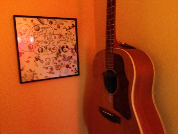 1958 Gibson J-50. This is the guitar I picked up at age 11 and learned to play. With Dad's help, of course. I usually leave it in open D tuning, thus the Led Zep III on the wall for companionship.