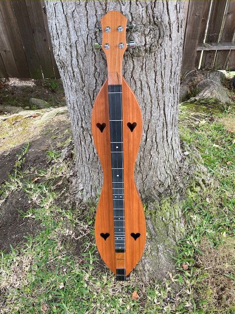 Cherry/Redwood McSpadden Dulcimer with 26" micarta fretboard overlay.