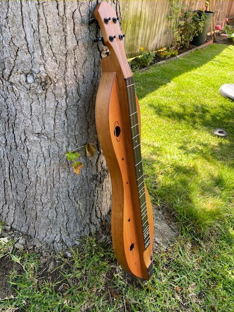 "Wink Dulcimer" designed by Kevin Roth and built by McSpadden Dulcimer Company
26" Fret Scale, Soundhole design by Robert Worth, Cherry back and sides, Redwood Top. Micarta fretboard overlay
Comes with a free Dulci-Meditation lesson by Kevin Roth himself!