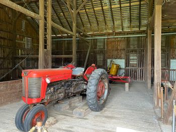 The red tractor in the 1887 bank barn that held hay and straw and the cattle stalls near the house. Ike used this tractor for his fields. In the 1950's, the barn housed several ponies and horses for his grandchildren.