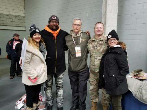 B.Taylor takes with active duty and veterans meeting George Mcklaskey, the owner of The Chicago Bears.