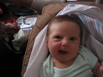 One of Daisy's early crooked smiles. Now her smiles are straight, but she has these great big teeth -- seriously, as big as corn nuts -- so it's still a little goofy. So cute though.
