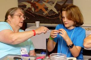 Gwen Weatherbie (L) teaches wire-wrapping for Road Scholars at YMCA Trout Lodge.