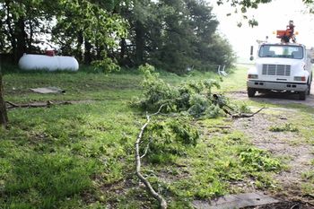 another view of the pile in the side yard. Electrician truck to repair the electric line to the garage.