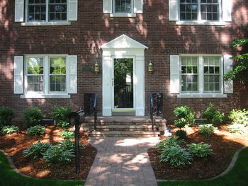 A new and elegant entry- Unilock wallstone porch with paver inset as well as paver walkway - original iron railings were sandblasted, painted and reinstalled What a difference!!