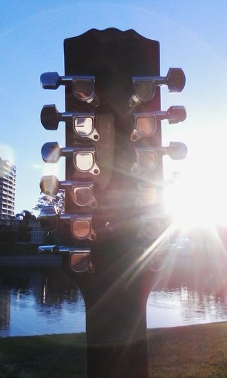 My Martinez 12 String Guitar Enjoying a Sundowner across from man made Chevron Island Gold Coast QLD Australia