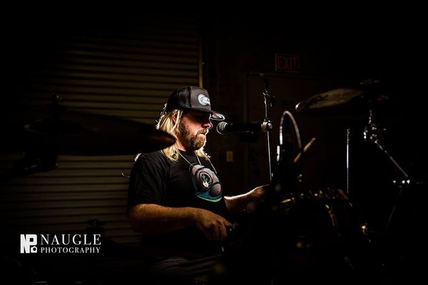 Scott Clayton (Drums) started his passion for music as a child. Vocal & guitar lessons at 7 years of age was the jumpstart. He picked up the drums at 13 years old & never looked back. Since high school he's been in punk, metal, blues, surf guitar & reggae bands and has 33 years of drumming experience.
He is also the founder of ON POINT PROMOTIONS, a music booking agency based out of Encinitas, CA. He's been hosting over 500 music events per year for over 10 years. He's nationally known as a professional music booking agent & currently booking shows in California, Michigan, New Jersey, & Hawaii.
During his 10 years as a professional music booking agent, he's created city functions, hosted street fairs, city beach festivals, major concert events in large venues, and is hired by Belly Up Tavern (San Diego's Premier Music Venue) as a representative at many major Southern California music festivals. So, needless to say he's great to have on the team!