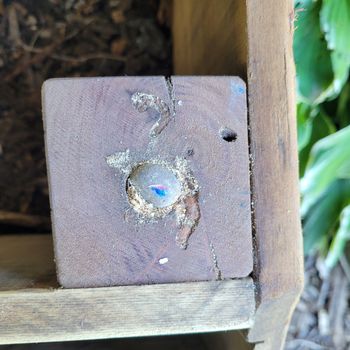 a stone embedded in the wood to keep the frame slightly elevated so that heat leaves at least a bit.