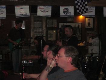 A customer enjoys a cool refreshing beverage while the L-Town Allstars jam, Dillinger's, Lafayette, CO, 1-28-2011.