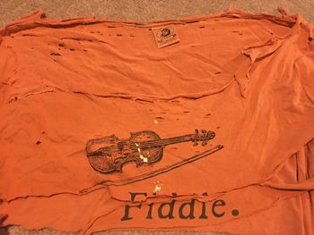 Long time favorite tee shirt was so holy it was approaching sainthood. Divine inspiration has given it a new life as a Bag-O-Rags mandolin strap.