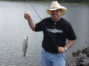 2006 - Pinetop AZ - Seems no matter what time of year we are up here, we
manage to get in a bit of fishing. Ken seems to have caught the
big fish of the week!